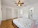 Bedroom with wood floors, ceiling fan, closet, and ensuite access at 147 114Th Ne Ave # 147, St Petersburg, FL 33716
