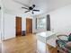 Bedroom featuring laminate floors, a ceiling fan, and spacious closets at 147 114Th Ne Ave # 147, St Petersburg, FL 33716