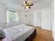 Bedroom featuring laminate floors, a window, and spacious closets at 147 114Th Ne Ave # 147, St Petersburg, FL 33716