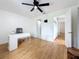 Spacious bedroom with laminate floors, a ceiling fan, and ample closet space at 147 114Th Ne Ave # 147, St Petersburg, FL 33716