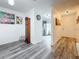 Inviting entryway featuring wood floors and stylish decor leading to kitchen at 147 114Th Ne Ave # 147, St Petersburg, FL 33716