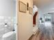 Inviting entryway featuring wood-look flooring, staircase, and a convenient half bathroom at 147 114Th Ne Ave # 147, St Petersburg, FL 33716