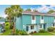 Inviting two-story home with a blue exterior, complemented by a well-manicured lawn at 147 114Th Ne Ave # 147, St Petersburg, FL 33716