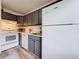 Cozy kitchen featuring gray cabinets, white appliances, and updated countertops at 147 114Th Ne Ave # 147, St Petersburg, FL 33716