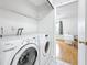 Laundry room area including washer, dryer, and storage shelving at 147 114Th Ne Ave # 147, St Petersburg, FL 33716