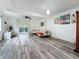 Bright living room with modern furnishings, wood floors, and sliding glass doors at 147 114Th Ne Ave # 147, St Petersburg, FL 33716