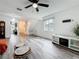 Open living area with wood floors, access to kitchen and staircase at 147 114Th Ne Ave # 147, St Petersburg, FL 33716