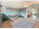 Enclosed patio area featuring tile floors, ceiling fan, and colorful hammock with sliding glass door at 147 114Th Ne Ave # 147, St Petersburg, FL 33716
