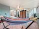 Covered patio with hammock, tile flooring, and storage cabinet, accessible via sliding glass door at 147 114Th Ne Ave # 147, St Petersburg, FL 33716