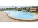 Large outdoor swimming pool with lounge chairs and manicured landscaping at 147 114Th Ne Ave # 147, St Petersburg, FL 33716
