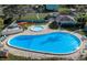 Aerial view of a large outdoor pool and lounging area with many chairs at 147 114Th Ne Ave # 147, St Petersburg, FL 33716