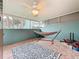 Screened porch with tiled floor, rug, and hammock at 147 114Th Ne Ave # 147, St Petersburg, FL 33716