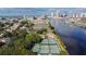 Panoramic aerial view features multiple tennis courts near the water, with the city skyline in the distance at 150 Bosphorous Ave, Tampa, FL 33606