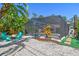 Backyard with a screened pool enclosure, an outdoor seating area, lush landscaping and a fire pit at 150 Bosphorous Ave, Tampa, FL 33606
