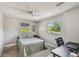 This bedroom has neutral walls, light-colored carpet, a ceiling fan, and a work space at 150 Bosphorous Ave, Tampa, FL 33606