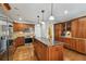 Spacious kitchen with stainless steel appliances, a large island, granite countertops, and custom cabinetry at 150 Bosphorous Ave, Tampa, FL 33606