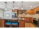 Open kitchen featuring stainless steel appliances, granite countertops, a center island, and custom cabinetry at 150 Bosphorous Ave, Tampa, FL 33606