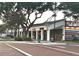 Retail storefronts on Biscayne Avenue with holiday lights strung on trees lining the brick sidewalk at 150 Bosphorous Ave, Tampa, FL 33606