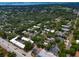 An aerial view of the neighborhood showcases the mature trees, blue ocean, and dense residential landscape at 1501 Howard Pl, Largo, FL 33770