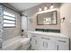 Updated bathroom features a shower/tub combo, a large mirror, and a white vanity at 1501 Howard Pl, Largo, FL 33770