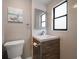 Bathroom with light wooden drawers under a white sink and a framed mirror hanging above the sink at 1501 Howard Pl, Largo, FL 33770