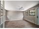 The bedroom showcases wood floors, neutral paint, modern lighting, and a door to the exterior of the house at 1501 Howard Pl, Largo, FL 33770