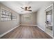 Bedroom featuring wood flooring, neutral paint, modern ceiling fan, and natural light from the windows at 1501 Howard Pl, Largo, FL 33770