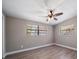 The bedroom features hard wood floors, neutral paint, updated lighting, and natural light from the window at 1501 Howard Pl, Largo, FL 33770