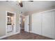 Bedroom features wood flooring, neutral paint, modern lighting, a large closet, and a door to the bathroom at 1501 Howard Pl, Largo, FL 33770