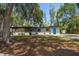 Single-story home with a pop of color from its vibrant blue door and freshly manicured lawn at 1501 Howard Pl, Largo, FL 33770
