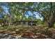 Charming single-story home with a lush, tree-filled front yard, offering shade and curb appeal at 1501 Howard Pl, Largo, FL 33770