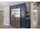 Modern kitchen featuring stainless steel refrigerator, navy cabinets and a coffee bar at 1501 Howard Pl, Largo, FL 33770