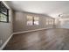 Bright living room features stylish wood flooring, neutral paint, and lots of natural light from multiple windows at 1501 Howard Pl, Largo, FL 33770
