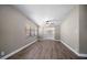 Open living room showcases wood flooring, neutral paint, modern lighting, and access to the backyard at 1501 Howard Pl, Largo, FL 33770