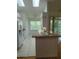 Bright kitchen featuring white appliances and tile flooring; open layout to encourage an airy atmosphere at 1605 Send Way, Lutz, FL 33549