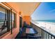 Balcony with seating overlooking a stunning beach, a perfect spot for relaxation and ocean views at 17334 Gulf Blvd # 203, North Redington Beach, FL 33708