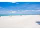 Beautiful beach view with white sand and turquoise water under a clear blue sky at 17334 Gulf Blvd # 203, North Redington Beach, FL 33708