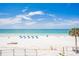 Beautiful beach with the Gulf of Mexico featuring white sand and lounge chairs with blue umbrellas at 17334 Gulf Blvd # 203, North Redington Beach, FL 33708