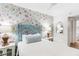 Bedroom features a comfortable bed, floral wallpaper, and matching bedside tables with lamps at 17334 Gulf Blvd # 203, North Redington Beach, FL 33708