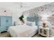 Cozy bedroom with floral wallpaper, white bedding, a ceiling fan, and a window for natural light at 17334 Gulf Blvd # 203, North Redington Beach, FL 33708
