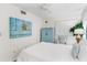 Bedroom featuring a plush bed, blue furniture, modern shutters, and a large painting of starfish at 17334 Gulf Blvd # 203, North Redington Beach, FL 33708