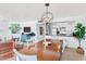 Open-concept dining area showcases wood table, complemented by living room furnishings, enhancing the inviting ambiance at 17334 Gulf Blvd # 203, North Redington Beach, FL 33708