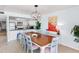Bright dining area with wood table, pendant lighting, and adjacent kitchen features open layout for modern living at 17334 Gulf Blvd # 203, North Redington Beach, FL 33708