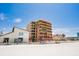 Beautiful beachfront condo building featuring balconies and beach access on a sunny day at 17334 Gulf Blvd # 203, North Redington Beach, FL 33708
