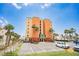 Charming multi-story building with palm trees and a parking lot in a sunny coastal setting at 17334 Gulf Blvd # 203, North Redington Beach, FL 33708
