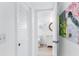 Bright hallway with a linen closet and an open view into the bathroom with modern fixtures at 17334 Gulf Blvd # 203, North Redington Beach, FL 33708