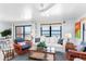 Living area featuring ocean views, a comfortable couch, and stylish decor with a ceiling fan at 17334 Gulf Blvd # 203, North Redington Beach, FL 33708