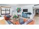 Comfortable living room with a TV, unique artwork, and plenty of seating at 17334 Gulf Blvd # 203, North Redington Beach, FL 33708