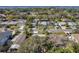 Aerial view of a residential area with well-maintained homes, green lawns, and easy access to nearby waterways at 1841 Douglas Ave, Dunedin, FL 34698