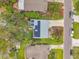 An aerial view of a home with a gray roof that features solar panels at 1841 Douglas Ave, Dunedin, FL 34698
